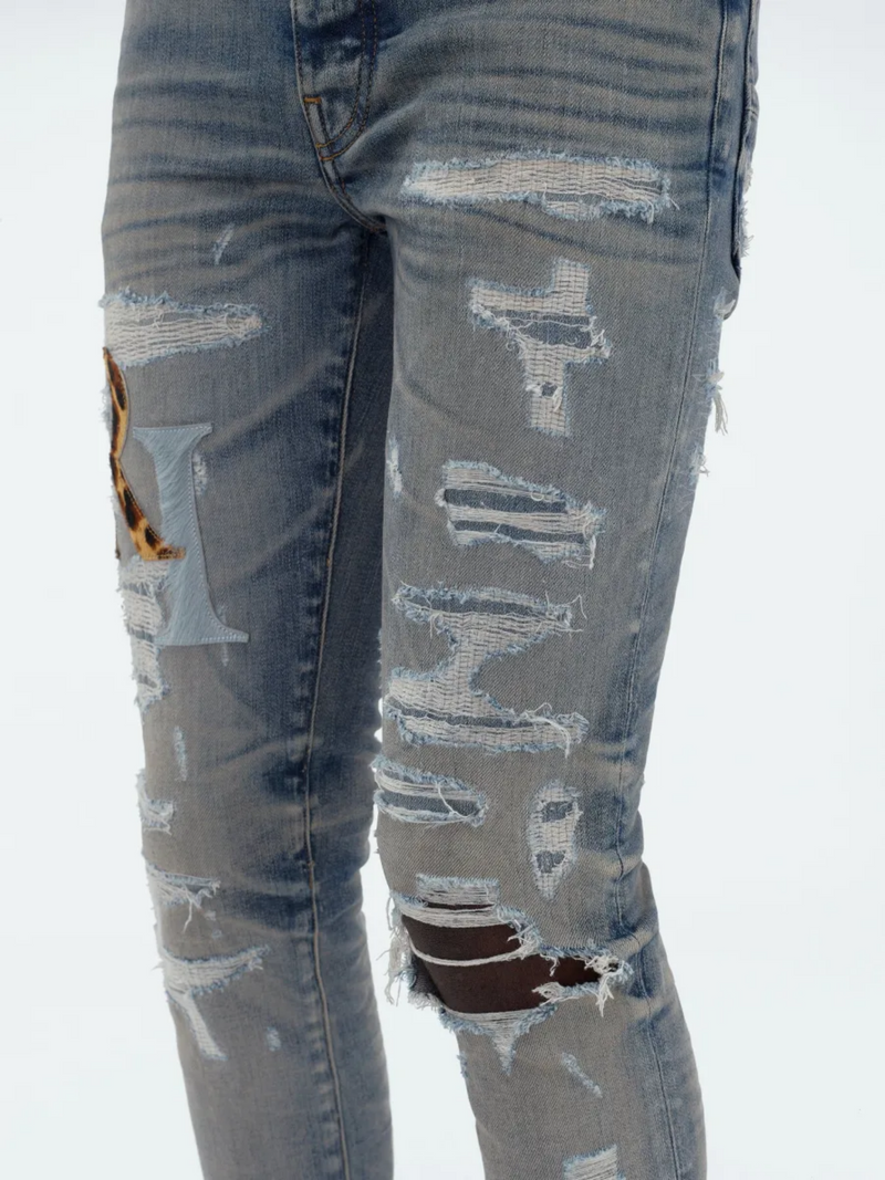 AMIRI STAGGERED LOGO JEANS INDIGO
