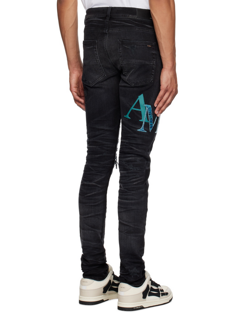 AMIRI STAGGERED LOGO JEANS BLACK