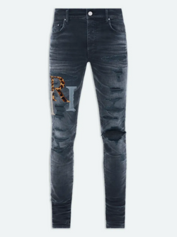 AMIRI STAGGERED LOGO JEANS INDIGO